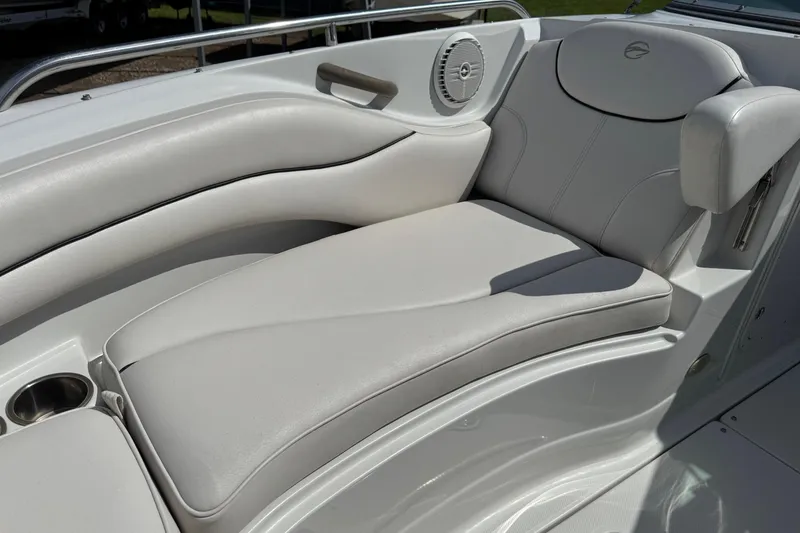 Slide: The Image of 2004 Crownline 248 BR boat interior with white leather seating and speaker. - 26