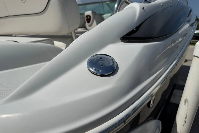 Slide: The Image of 2004 Crownline 248 BR boat detail, showcasing sleek white design and chrome accents. - 6