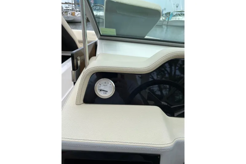Slide: The Image of 2020 Regal 26 OBX dashboard with fuel gauge, marina background. - 10