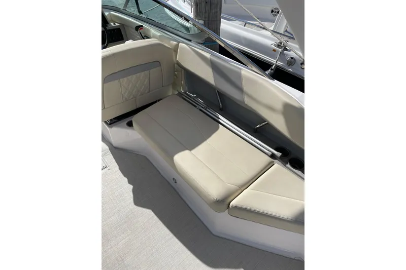 Slide: The Image of 2020 Regal 26 OBX boat interior seating with beige upholstery and cup holders. - 12