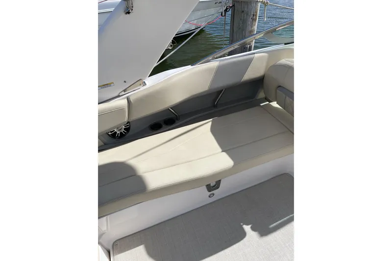 Slide: The Image of 2020 Regal 26 OBX boat interior with beige seating and speaker detail. - 13