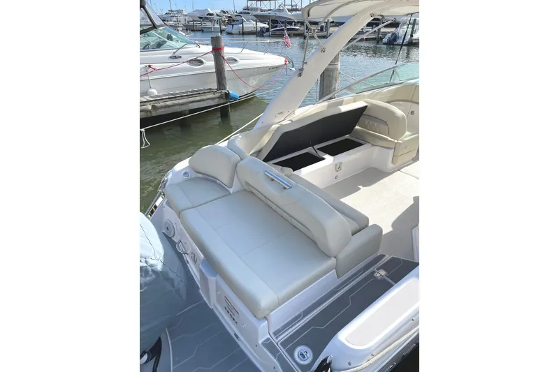 Slide: The Image of 2020 Regal 26 OBX boat with spacious seating and storage at a marina. - 15
