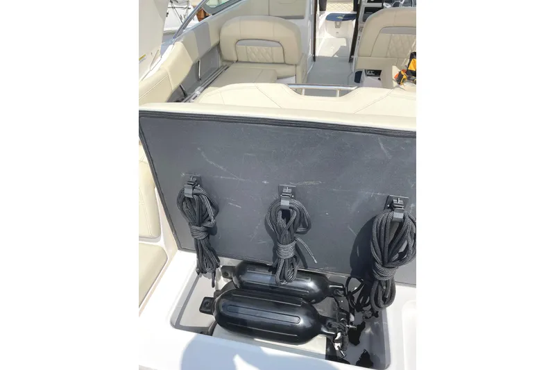 Slide: The Image of 2020 Regal 26 OBX boat storage compartment with ropes and fenders. - 16