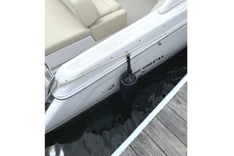 Slide: The Image of 2020 Regal 26 OBX boat docked, featuring beige seating and an orange toolbox. - 18
