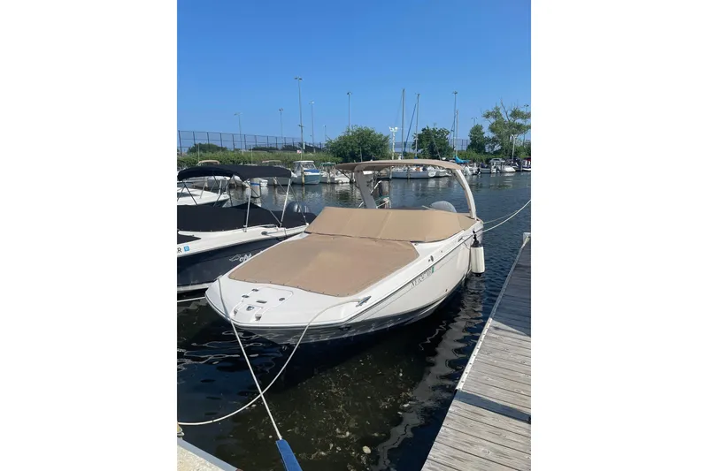Slide: The Image of 2020 Regal 26 OBX boat docked at marina under clear blue sky. - 22