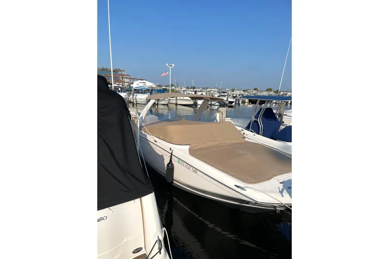 Slide: The Image of 2020 Regal 26 OBX boat docked at marina under clear blue sky. - 24