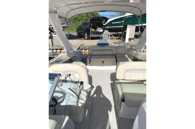 Slide: The Image of 2020 Regal 26 OBX boat interior with beige seating and open deck layout. - 25