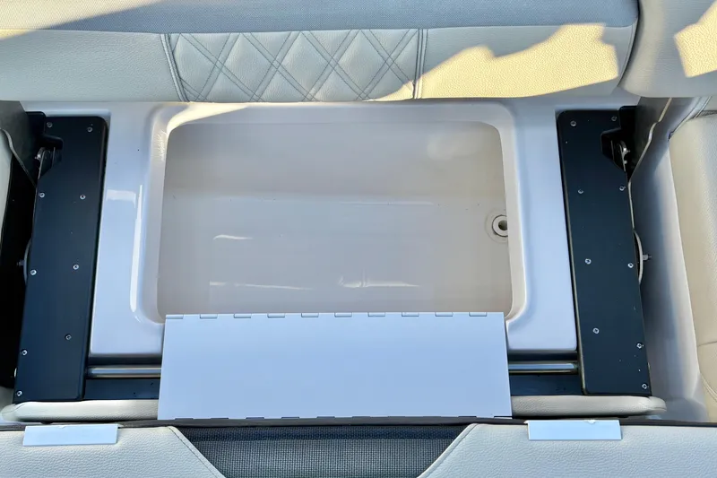 Slide: The Image of 2020 Regal 26 OBX boat storage compartment with cushioned seating and diamond stitching. - 30
