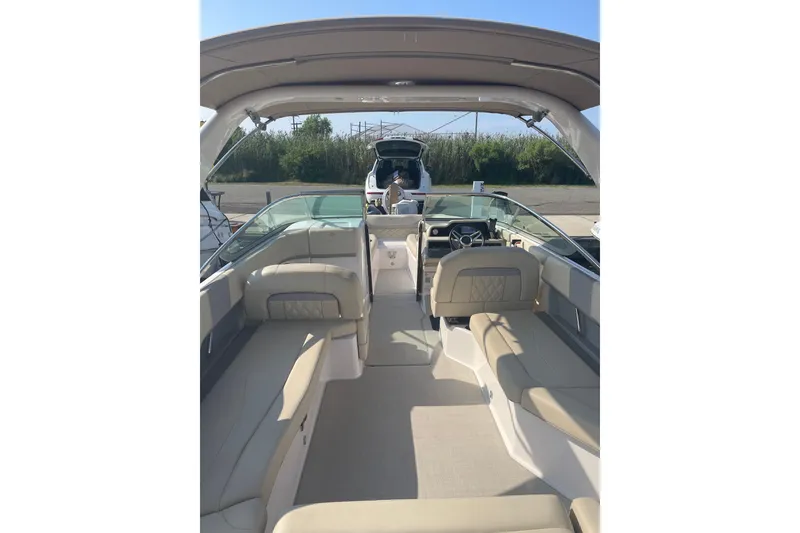Slide: The Image of 2020 Regal 26 OBX boat interior with beige seating and modern dashboard. - 4