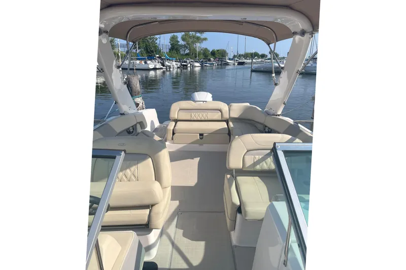 Slide: The Image of 2020 Regal 26 OBX boat interior with beige seating, docked at marina. - 5
