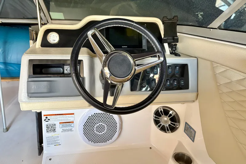 Slide: The Image of 2020 Regal 26 OBX boat dashboard with steering wheel and control panel. - 9
