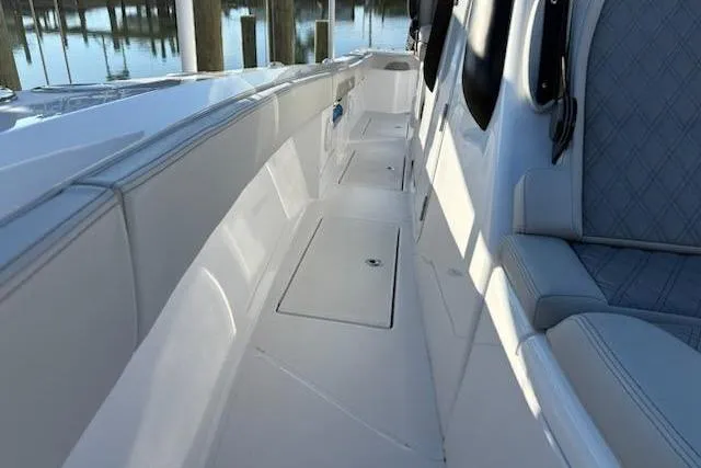 Slide: The Image of 2025 Front Runner 36 Center Console boat interior with sleek seating and storage compartments. - 13