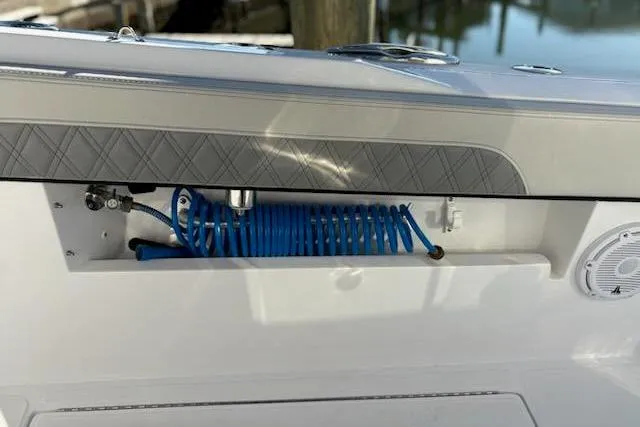 Slide: The Image of 2025 Front Runner 36 Center Console boat with coiled blue hose and speaker detail. - 20