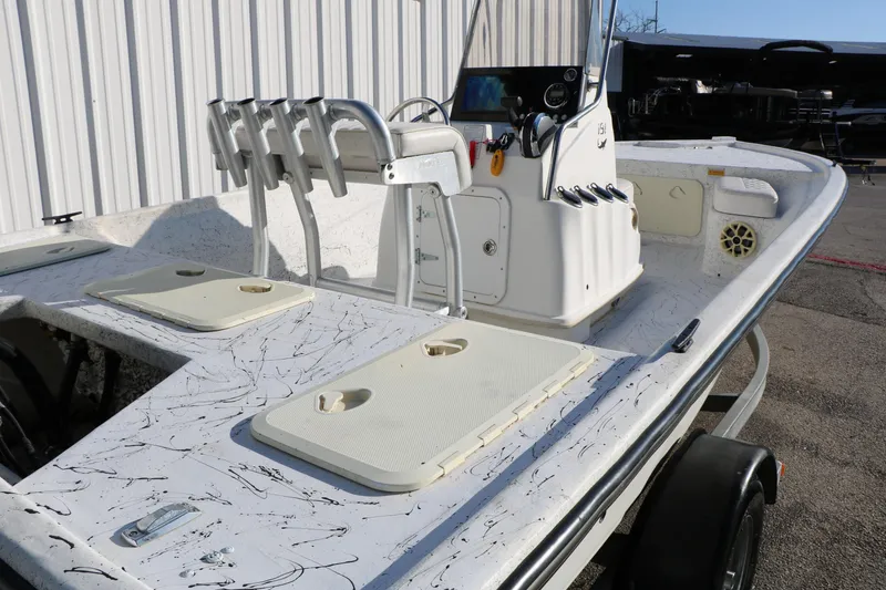 Slide: The Image of 2007 Mako 191 Inshore boat with fishing rod holders and storage compartments. - 12