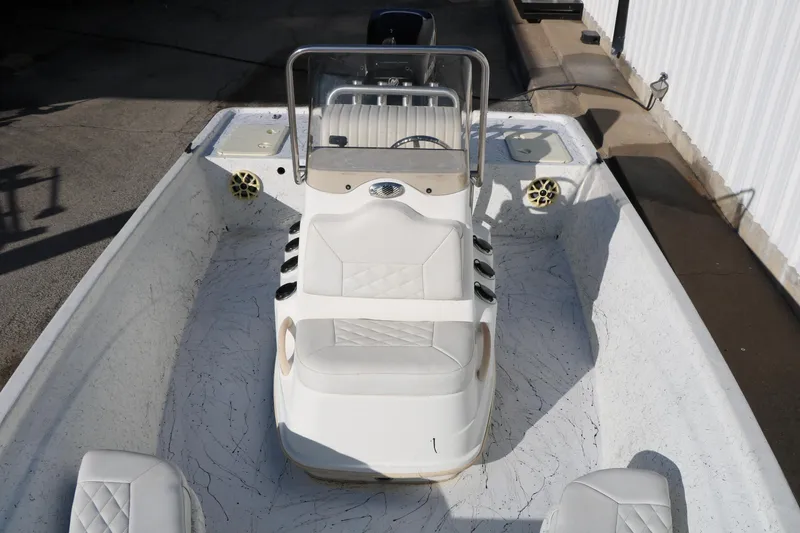 Slide: The Image of 2007 Mako 191 Inshore boat interior with white seating and steering console. - 18