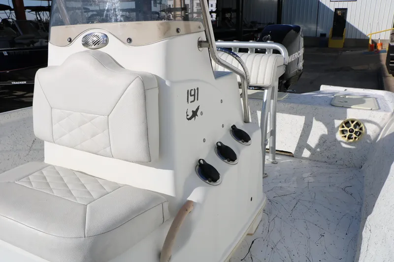 Slide: The Image of 2007 Mako 191 Inshore boat interior with white seating and Mercury engine. - 20