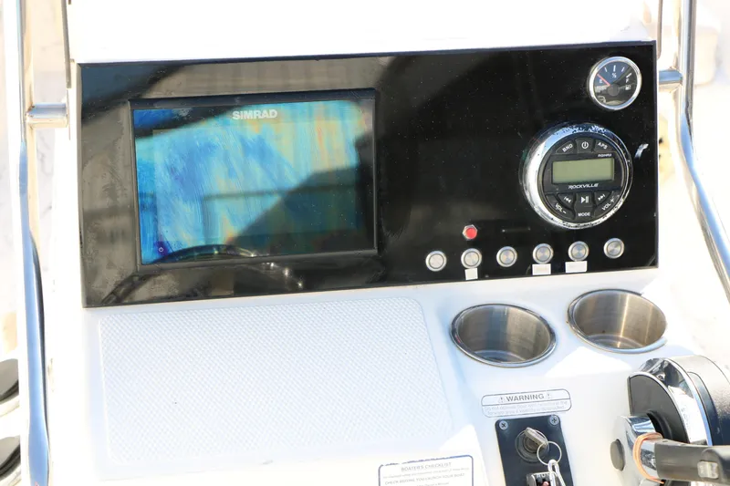 Slide: The Image of Control panel of a 2007 Mako 191 Inshore boat with Simrad display and Rockville audio system. - 24