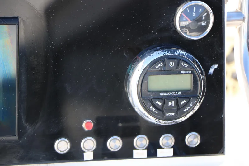 Slide: The Image of Dashboard of 2007 Mako 191 Inshore boat with Rockville audio system and fuel gauge. - 25