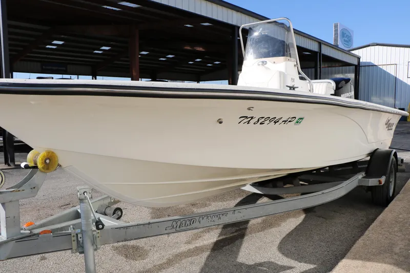 Slide: The Image of 2007 Mako 191 Inshore boat on trailer, parked in a covered area. - 7