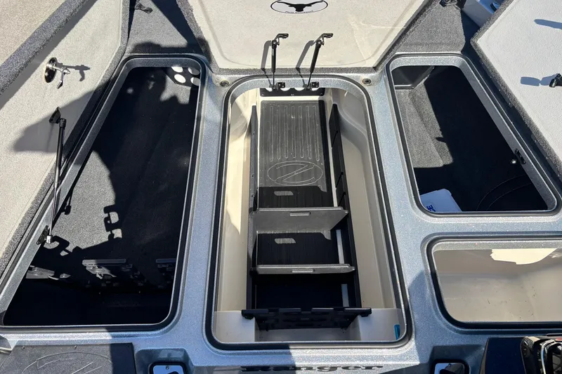 Slide: The Image of 2018 Ranger Z519 Comanche boat storage compartments, open and empty, showcasing interior layout. - 6