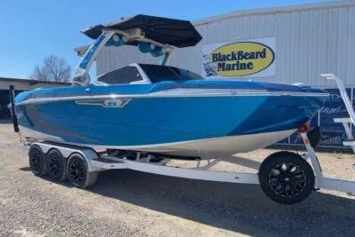 The Image of 2025 Tigé Ultré 25ZX boat in vibrant blue on a trailer at BlackBeard Marine. - 0