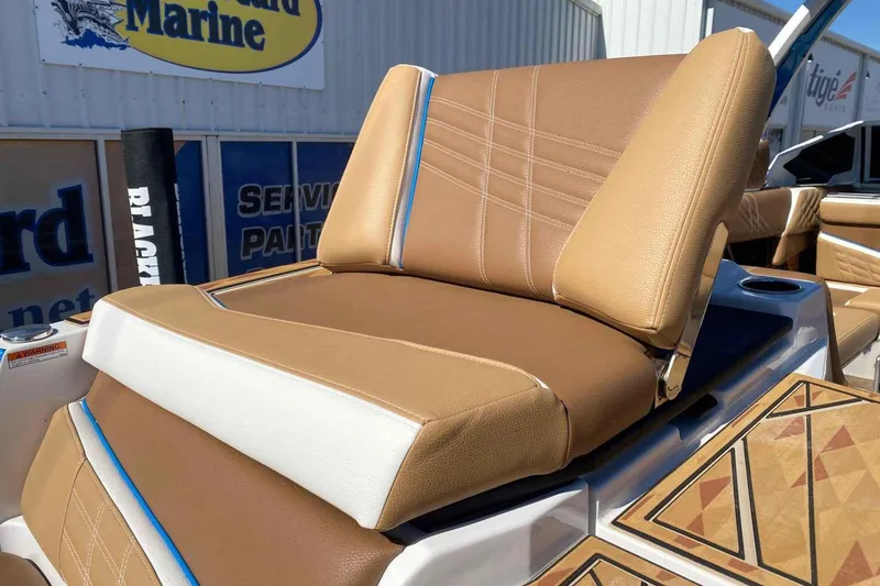 Slide: The Image of 2025 Tigé Ultré 25ZX boat seat with tan upholstery and blue accents. - 11