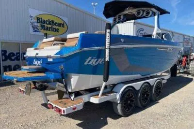 Slide: The Image of 2025 Tigé Ultré 25ZX boat in blue on a trailer at BlackBeard Marine dealership. - 4