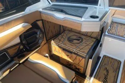 Slide: The Image of 2025 Tigé Ultré 25ZX boat interior with modern dashboard and stylish seating. - 9