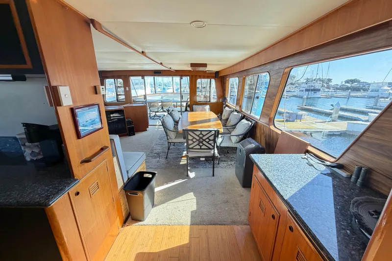 Slide: The Image of Interior of 1988 Cheoy Lee 66 Long Range MY yacht with spacious seating and large windows. - 11