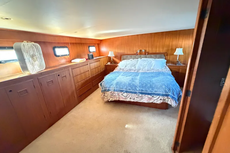 Slide: The Image of Luxurious bedroom in 1988 Cheoy Lee 66 Long Range MY yacht with wood paneling and cozy bedding. - 17