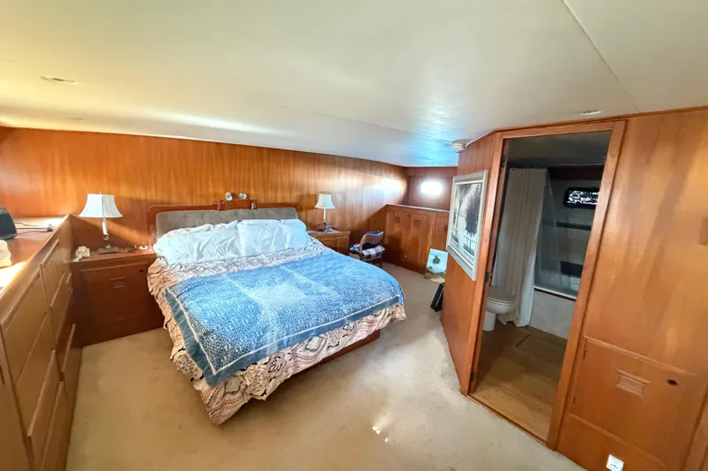 Slide: The Image of Luxurious bedroom on 1988 Cheoy Lee 66 Long Range MY yacht with wood paneling and ensuite bathroom. - 18