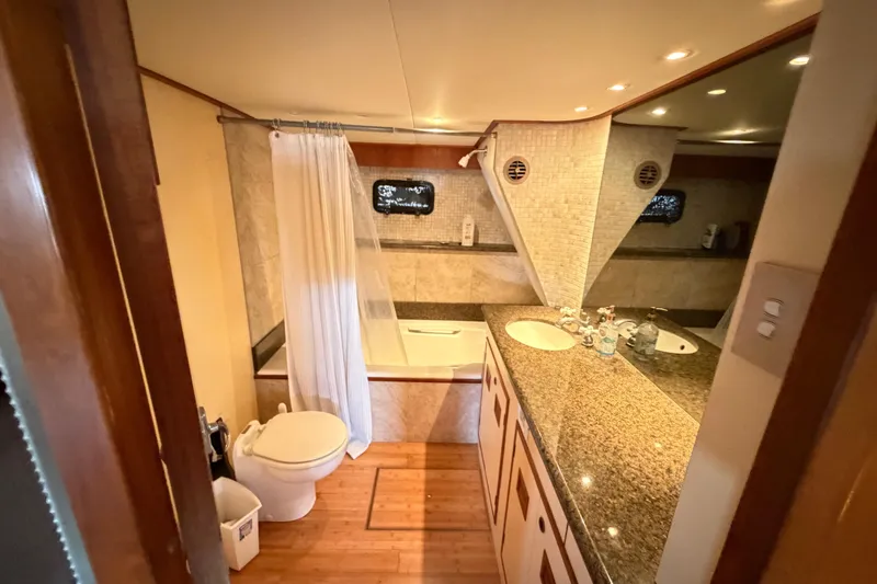 Slide: The Image of Luxurious bathroom in 1988 Cheoy Lee 66 Long Range MY yacht, featuring granite countertops and wood flooring. - 19