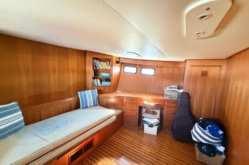 Slide: The Image of 1988 Cheoy Lee 66 Long Range MY cabin with wood paneling, bookshelves, and seating area. - 21