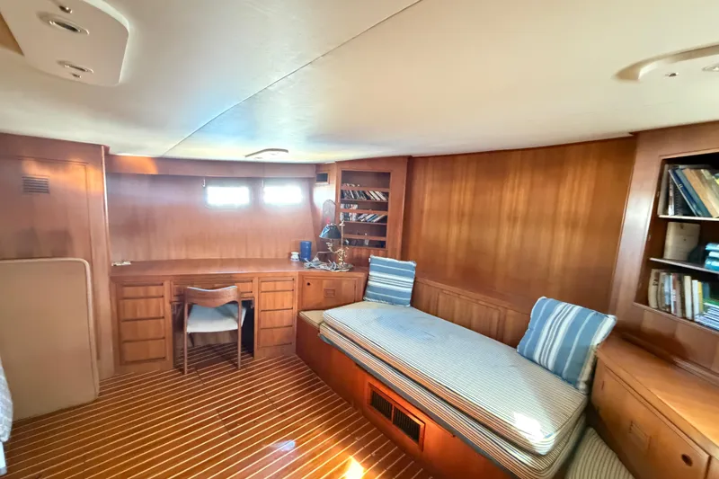 Slide: The Image of 1988 Cheoy Lee 66 Long Range MY interior with wooden decor, desk, and daybed. - 22