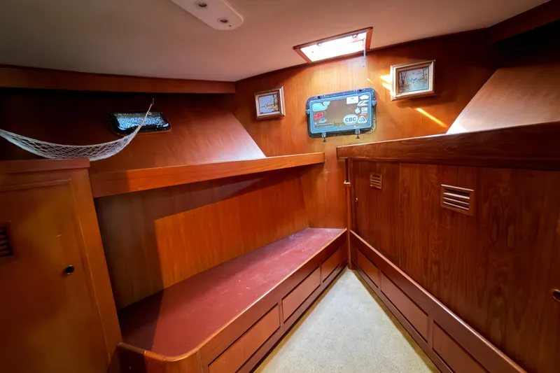 Slide: The Image of Interior of 1988 Cheoy Lee 66 Long Range MY yacht, featuring wooden cabinetry and cozy seating. - 24