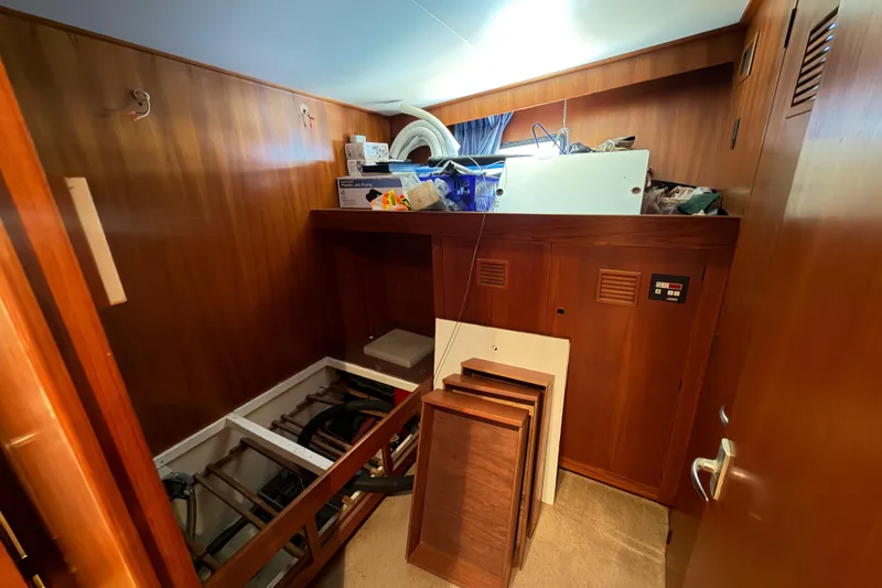 Slide: The Image of Interior storage area of 1988 Cheoy Lee 66 Long Range MY yacht with wooden paneling. - 27
