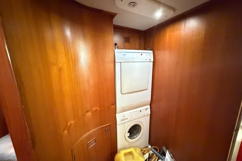 Slide: The Image of Laundry area with stacked washer and dryer in 1988 Cheoy Lee 66 Long Range MY yacht. - 28