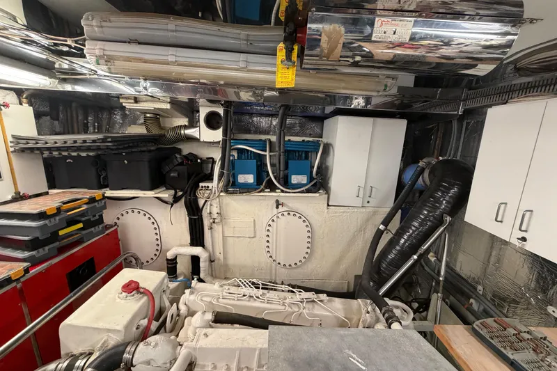 Slide: The Image of Engine room of 1988 Cheoy Lee 66 Long Range MY yacht, featuring equipment and storage. - 36