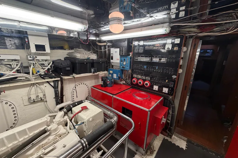 Slide: The Image of Engine room of 1988 Cheoy Lee 66 Long Range MY yacht, featuring control panels and machinery. - 37