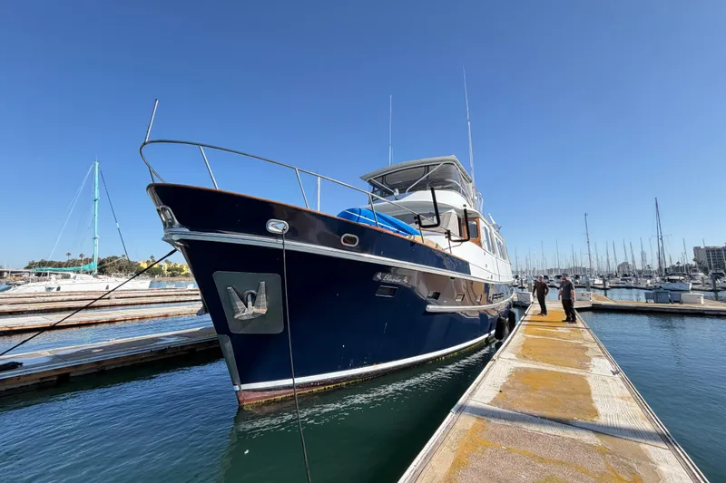 Slide: The Image of 1988 Cheoy Lee 66 Long Range MY yacht docked at marina under clear blue sky. - 4