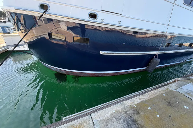 Slide: The Image of 1988 Cheoy Lee 66 Long Range MY yacht docked, reflecting on green water. - 44