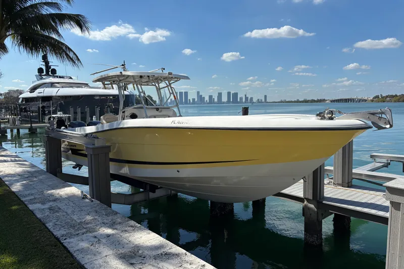 The Image of 2006 Hydra-Sports Vector 3300 CC boat docked by waterfront with city skyline. - 0