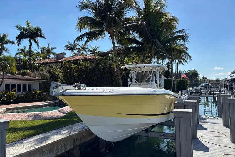 Slide: The Image of 2006 Hydra-Sports Vector 3300 CC boat docked near tropical palm trees. - 1