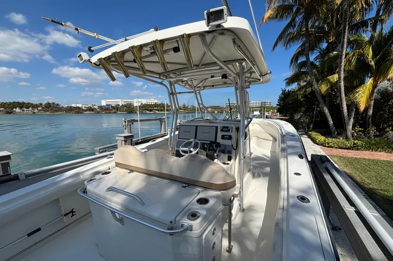 Slide: The Image of 2006 Hydra-Sports Vector 3300 CC boat docked by palm trees and water. - 11