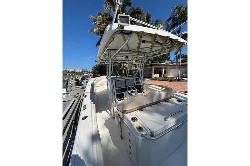 Slide: The Image of 2006 Hydra-Sports Vector 3300 CC boat docked, featuring a sleek console and canopy. - 12