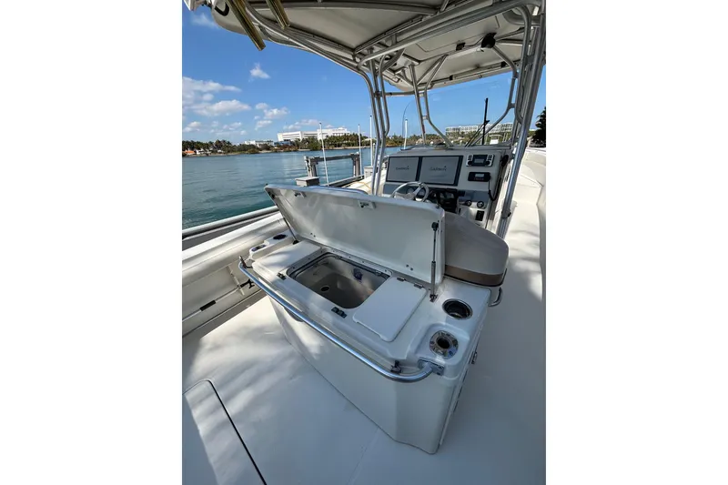 Slide: The Image of 2006 Hydra-Sports Vector 3300 CC boat interior with open storage compartment, helm, and ocean view. - 13