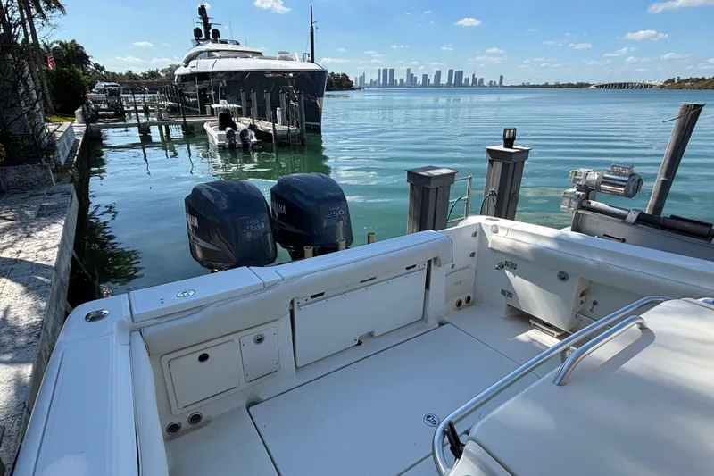 Slide: The Image of 2006 Hydra-Sports Vector 3300 CC docked, with city skyline in the background. - 14