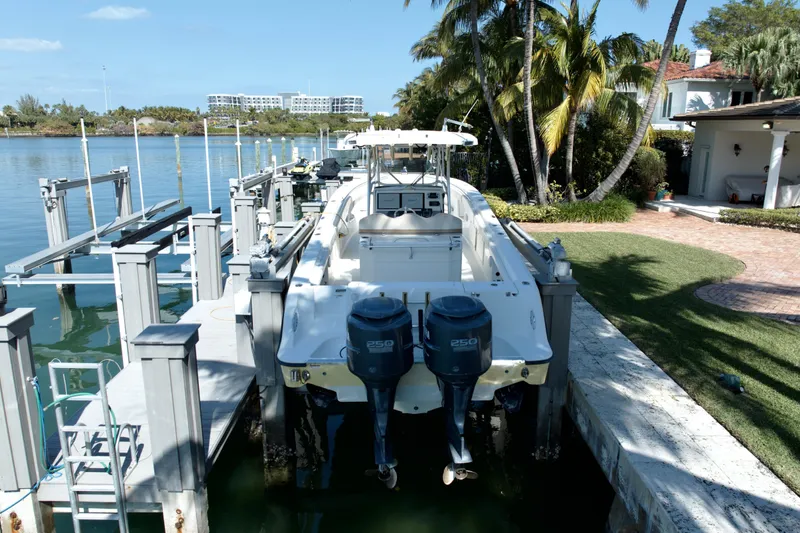 Slide: The Image of 2006 Hydra-Sports Vector 3300 CC docked by waterfront home with palm trees. - 2