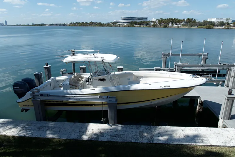 Slide: The Image of 2006 Hydra-Sports Vector 3300 CC boat docked by a serene waterfront. - 4