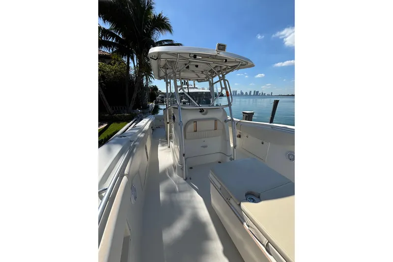 Slide: The Image of 2006 Hydra-Sports Vector 3300 CC boat docked by palm trees and waterfront skyline. - 5